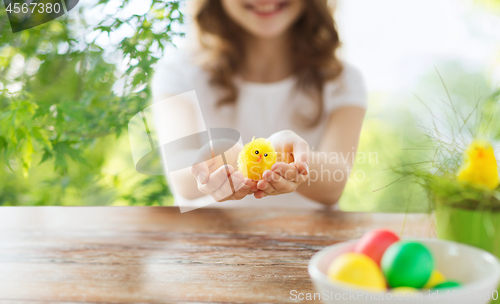 Image of close up of girl holding yellow toy chicken