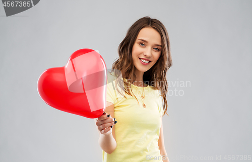 Image of teenage girl with red heart-shaped balloon