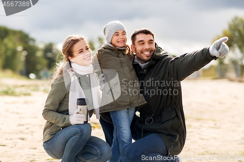 Image of happy family outdoors in autumn