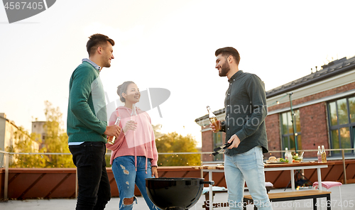 Image of happy friends having bbq party on rooftop