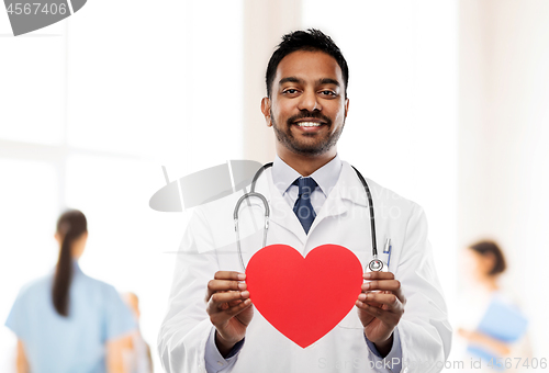 Image of smiling indian male doctor with red heart shape