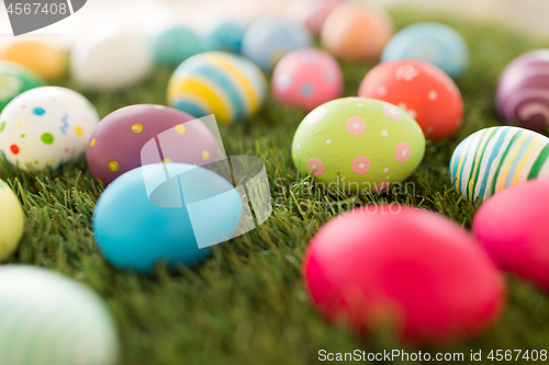 Image of colored easter eggs on artificial grass