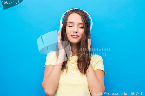 Image of happy young woman or teenage girl with headphones