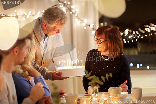 Image of happy family having birthday party at home