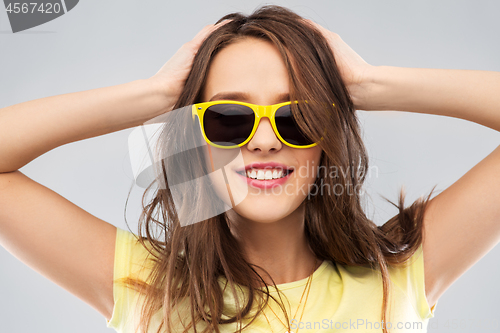 Image of teenage girl in yellow sunglasses and t-shirt