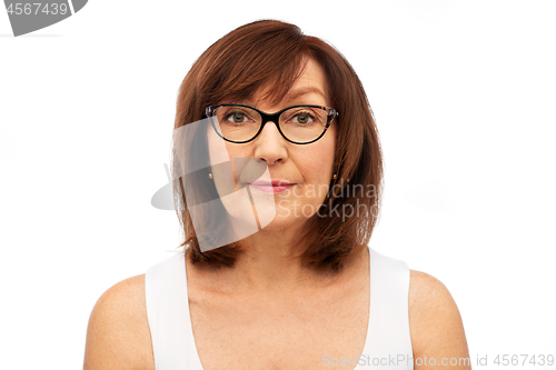 Image of portrait of senior woman in glasses over white