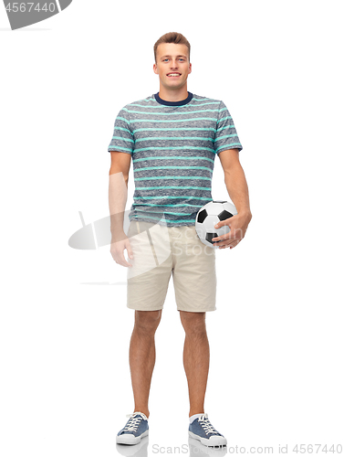 Image of smiling young man with soccer ball