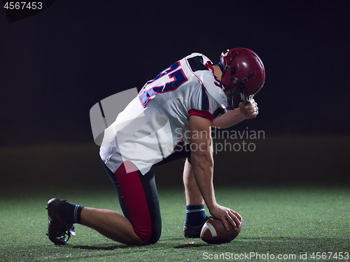 Image of American football player starting football game