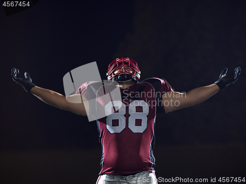 Image of american football player celebrating after scoring a touchdown