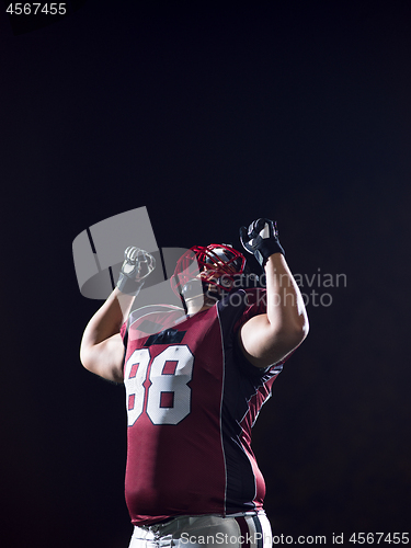 Image of american football player celebrating after scoring a touchdown