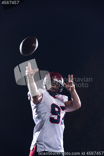 Image of american football player throwing rugby ball