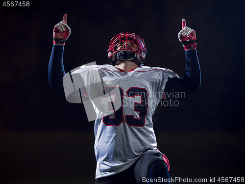 Image of american football player celebrating after scoring a touchdown