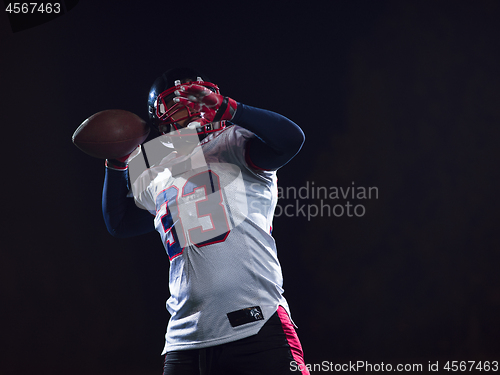 Image of american football player throwing rugby ball