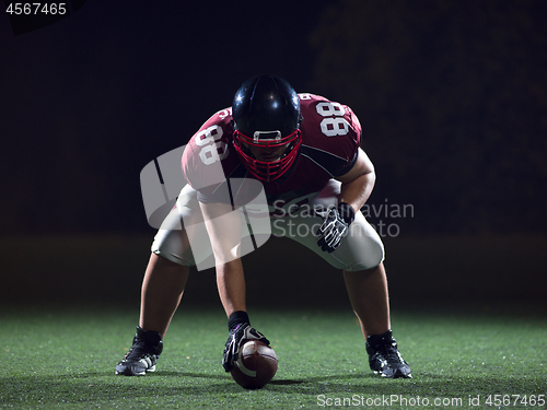 Image of American football player starting football game