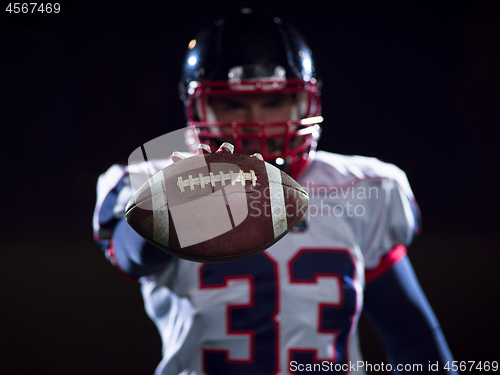 Image of portrait of confident American football player