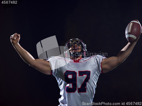 Image of american football player celebrating after scoring a touchdown