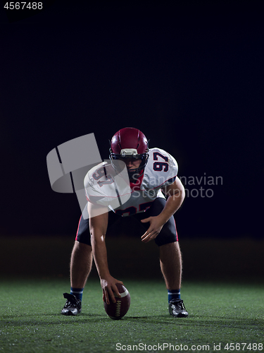 Image of American football player starting football game