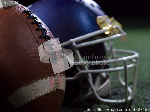 Image of closeup of american football and helmet