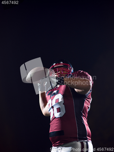 Image of american football player throwing rugby ball