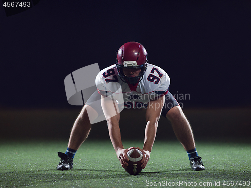 Image of American football player starting football game