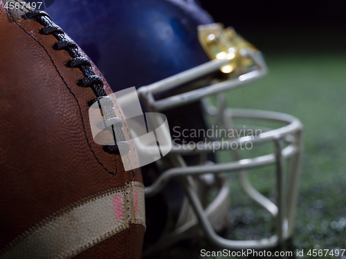 Image of closeup of american football and helmet