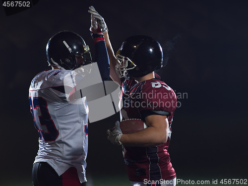 Image of american football players celebrating after scoring a touchdown