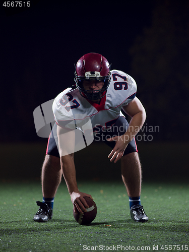 Image of American football player starting football game