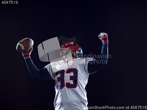 Image of american football player celebrating after scoring a touchdown