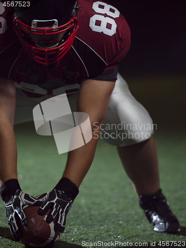 Image of American football player starting football game