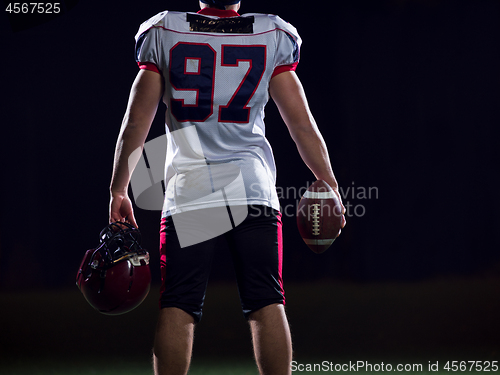 Image of rear view of young confident American football player