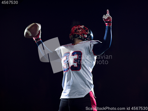 Image of american football player celebrating after scoring a touchdown