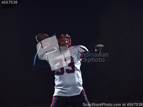 Image of american football player throwing rugby ball