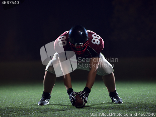 Image of American football player starting football game