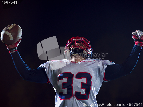 Image of american football player celebrating after scoring a touchdown