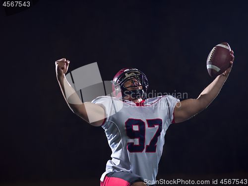 Image of american football player celebrating after scoring a touchdown