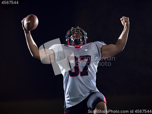 Image of american football player celebrating after scoring a touchdown