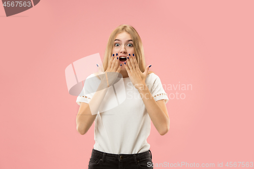 Image of Beautiful woman looking suprised isolated on pink