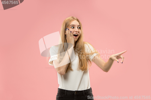 Image of Beautiful woman looking suprised isolated on pink