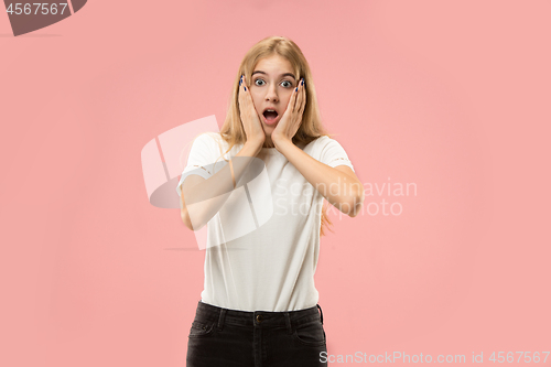 Image of Beautiful woman looking suprised isolated on pink