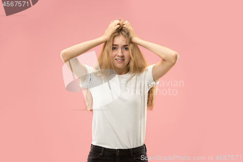 Image of Beautiful woman looking suprised and bewildered isolated on pink