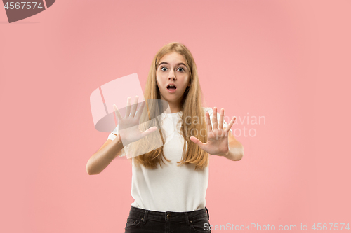 Image of Portrait of the scared woman on pink