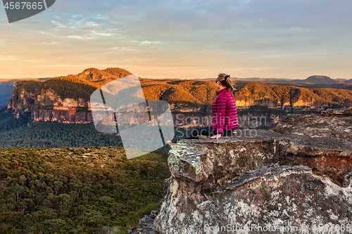 Image of Woman taking in early morning mountain views