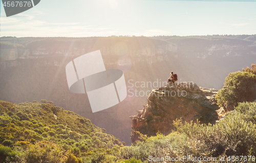 Image of Mountain explorer taking in views from a rock precipice