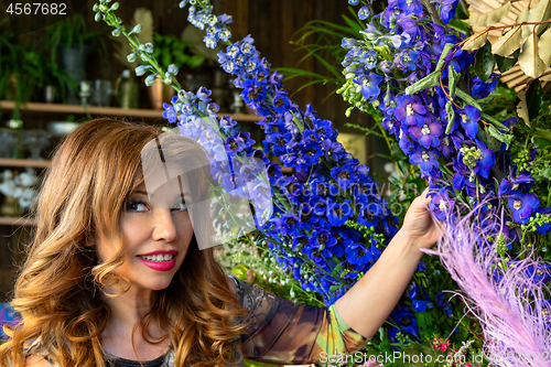 Image of Florist  shop owner or customer outside with flower displays