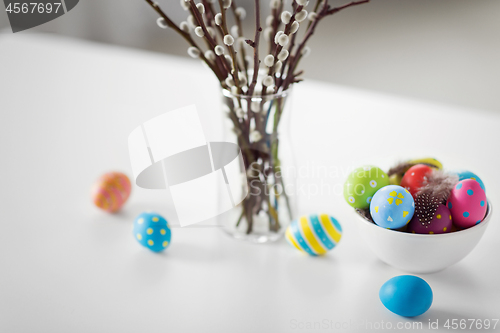 Image of pussy willow branches and colored easter eggs