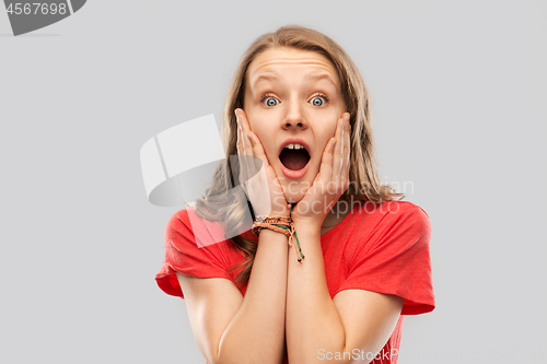 Image of shocked or scared teenage girl in red t-shirt