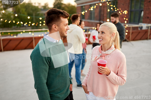 Image of friends with non alcoholic drinks at rooftop party