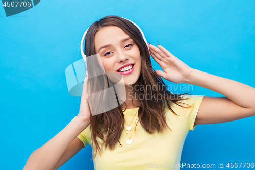 Image of happy young woman or teenage girl with headphones