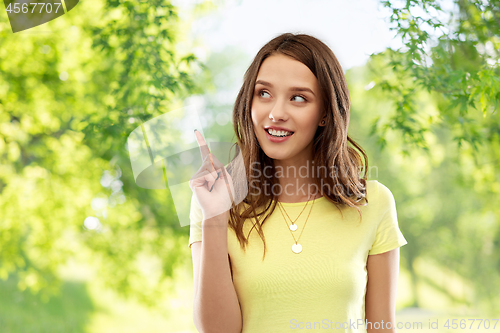 Image of young woman or teenage girl pointing finger up