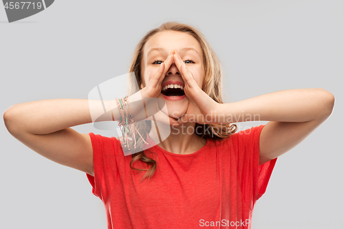 Image of happy teenage girl in red t-shirt shouting